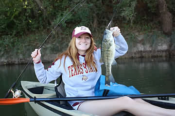 girl fishing from a boat